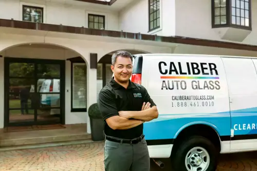 Caliber Auto Glass Mobile Repair Tech ready to replace a windshield at customer's home.