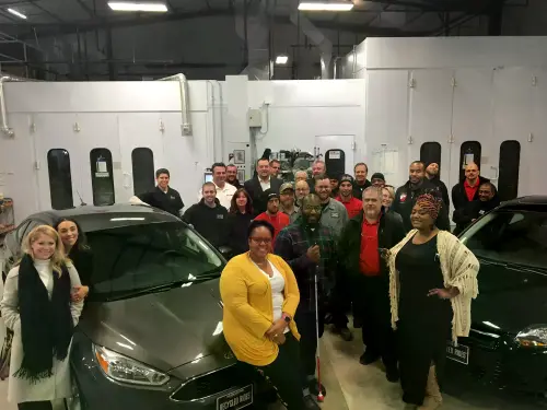 Recipients and the Caliber Collision team at a NABC Recycled Rides event.